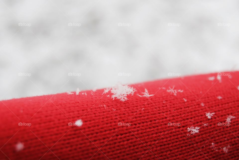 Snowflake on red woolen in winter