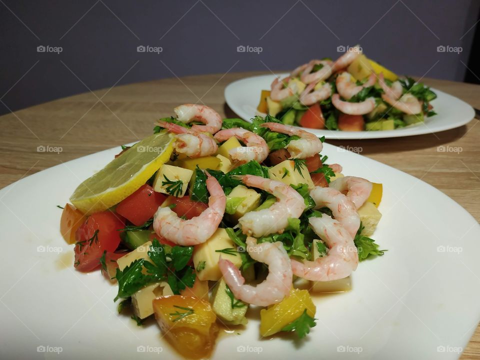delicious homemade salad with shrimps, cheese, mango and herbs, dressed with citrus sauce