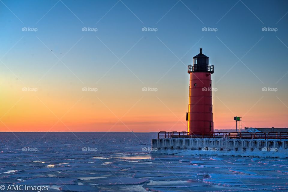 Red light house on Lake Michigan in the morning