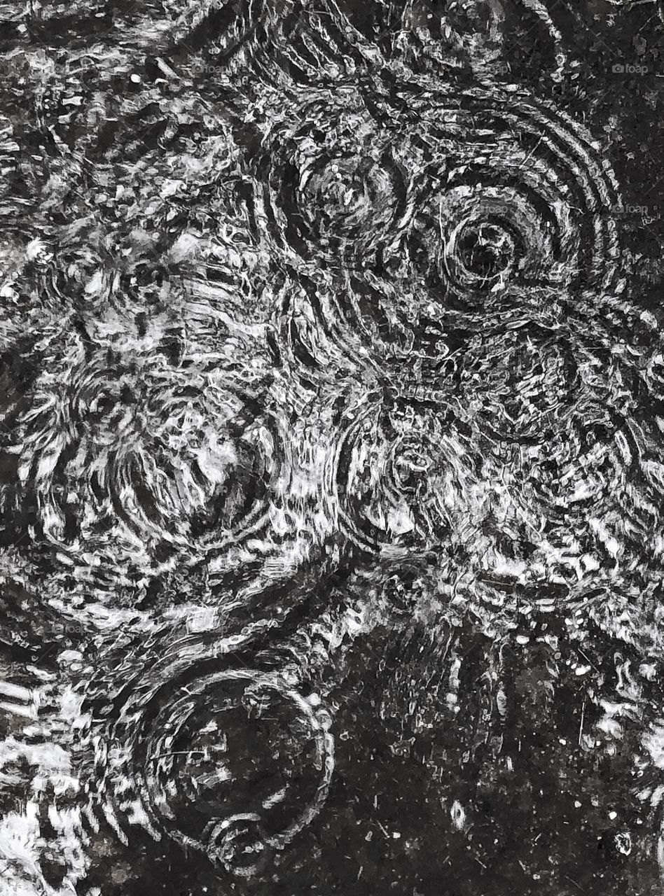 Rain drops in puddle 