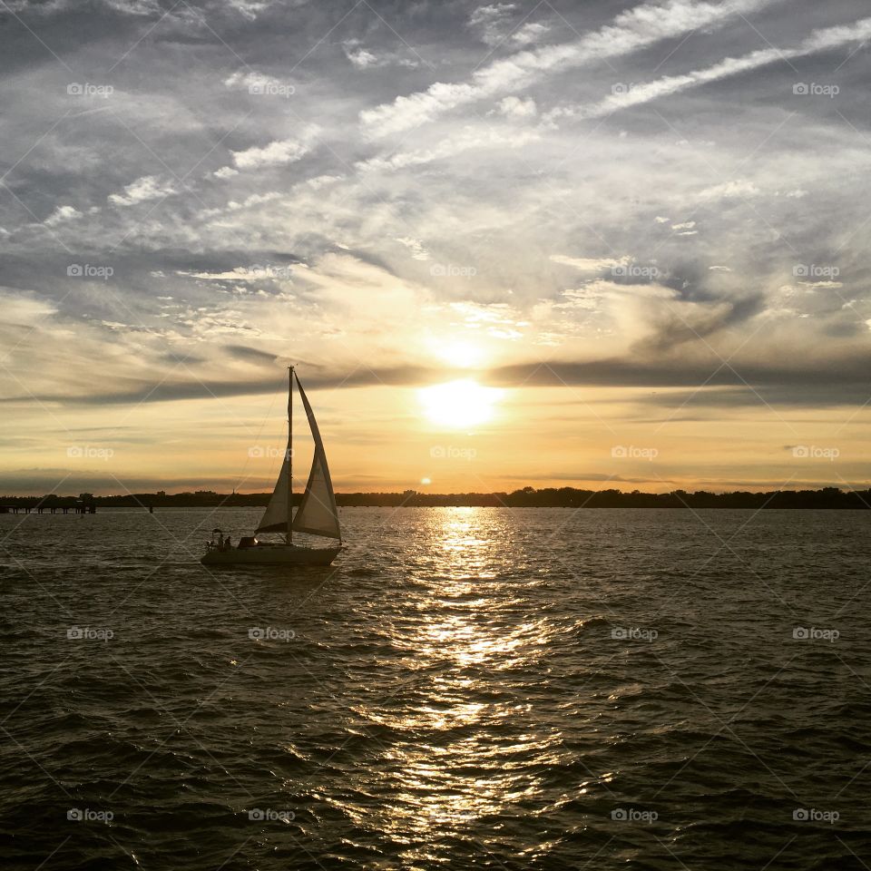 A sailboat in the sea during the sunset in summertime 