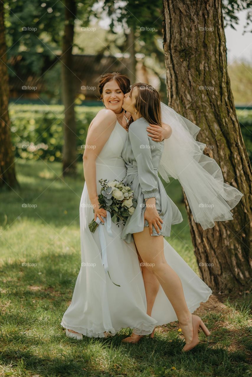 A happy photo of two friends, one of whom got married