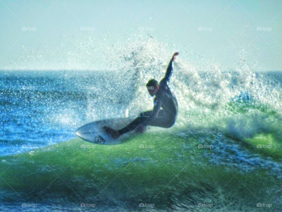 Epic Surfer Riding The Curl Of A Wave. Big Wave Surfing
