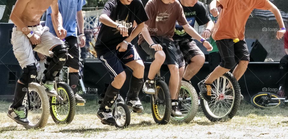 People competing in a unicycle race