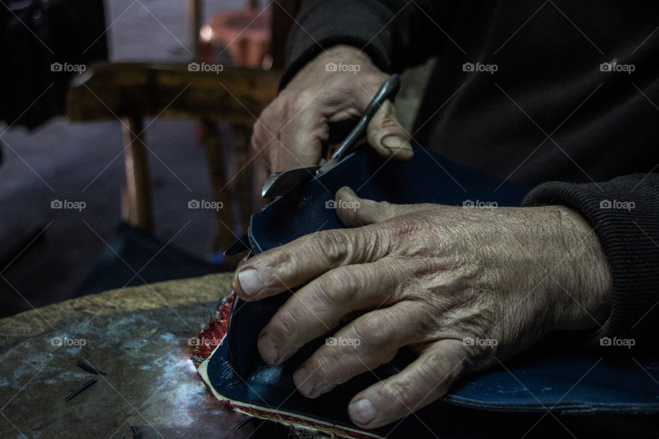 Close-up of a man creating handmade purses