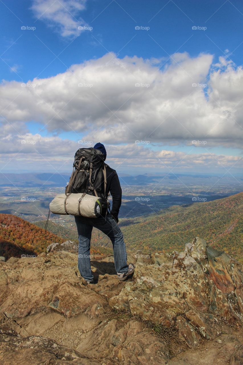 Backpacker admiring the view from the mountains.