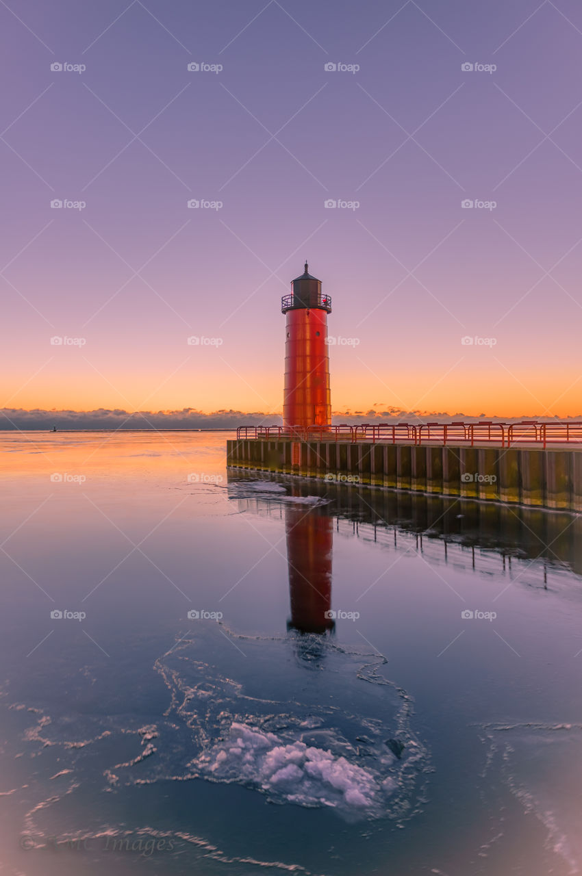 Red lighthouse at sunrise on Lake Michigan in Milwaukee Wisconsin
