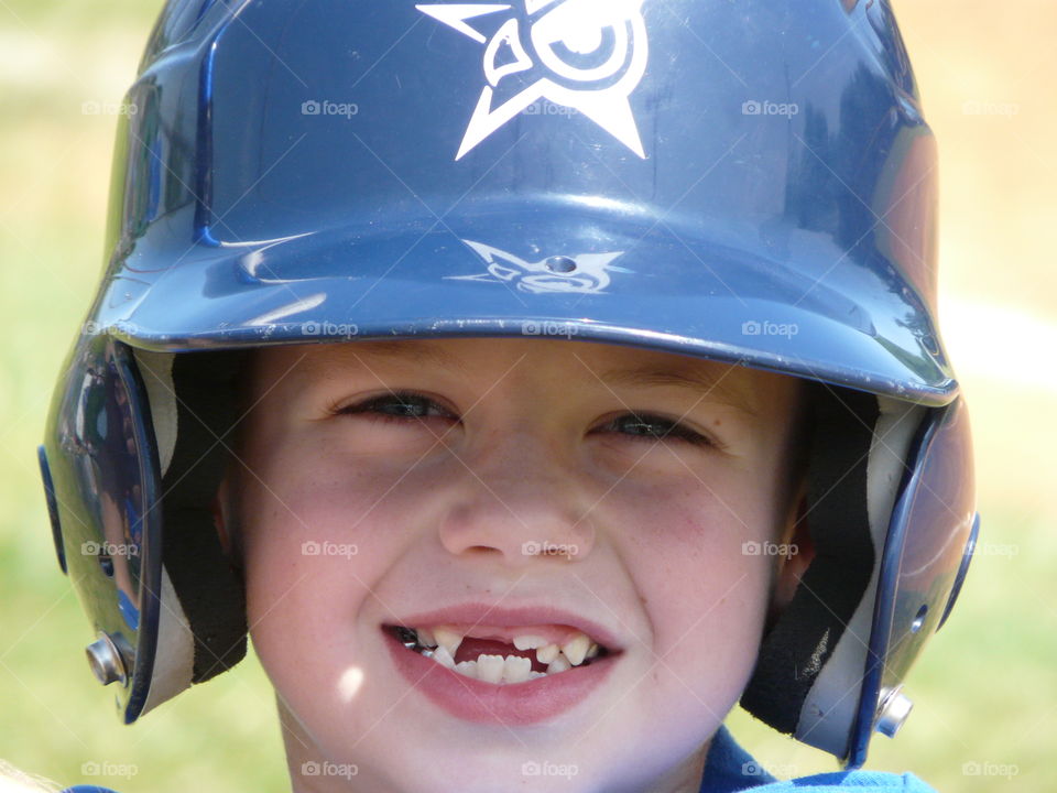 Close-up of a smiling boy wearing helmet