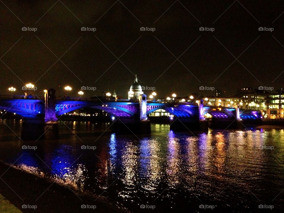 Southwark Bridge on the River Thames.. Night photography of the Southwark Bridge on the River Thames. St. Paul's Cathedral in the background.