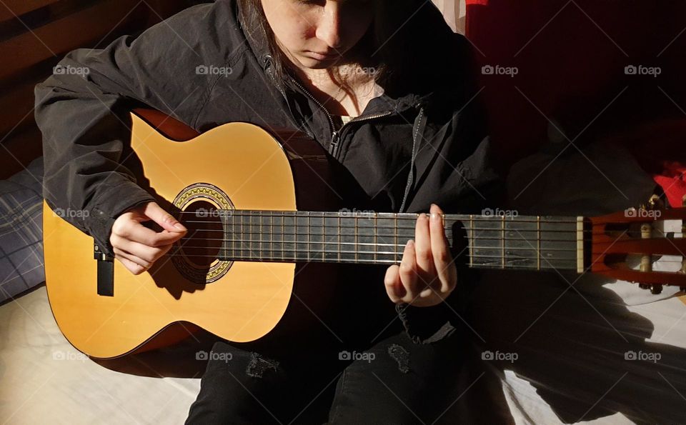 A moment in our personal space, playing the guitar, a very beautiful musical instrument and a spectacular sound