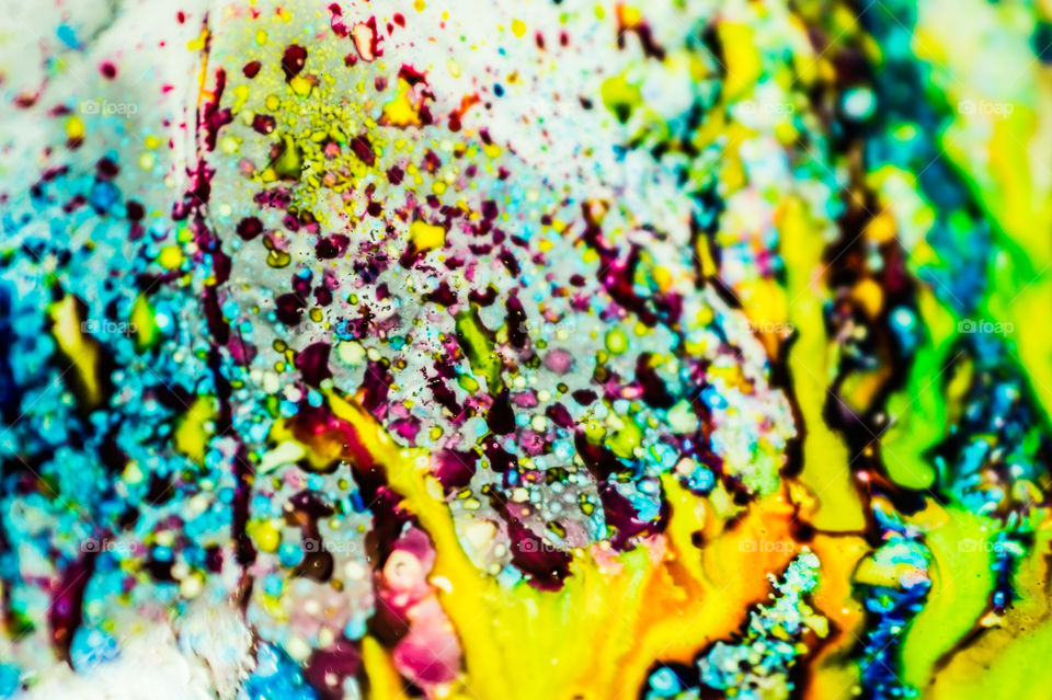 The ink to refill the printer cartridge was spilled onto the white washbasin and the paints blended into abstract drips and patterns