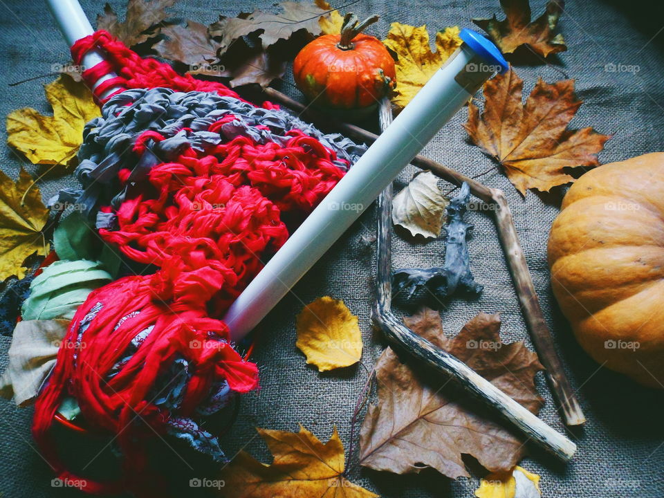 pumpkin, autumn leaves and knitting on the table