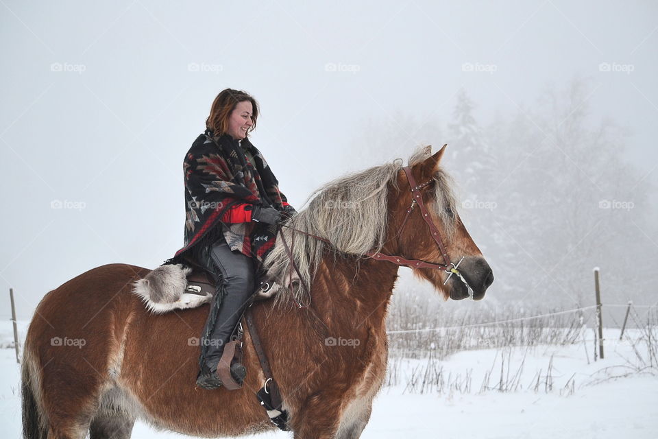 Woman riding her horse