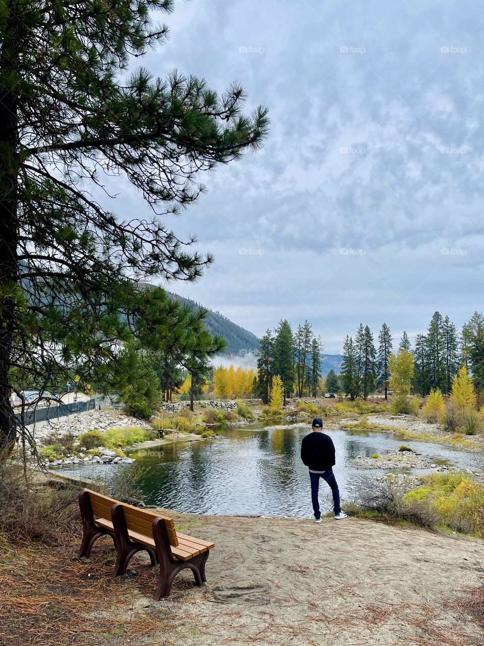 Faceless man near the autumn lake 