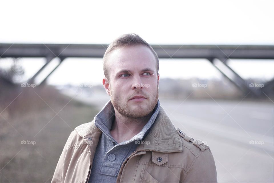 portrait of a tough man near the bridge