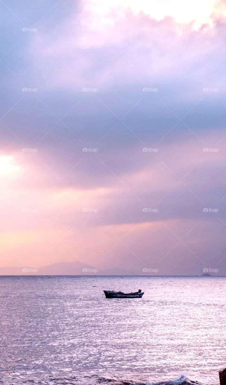 nice water view in side a small boat on water nice photo and also nice cloud effect peaceful view