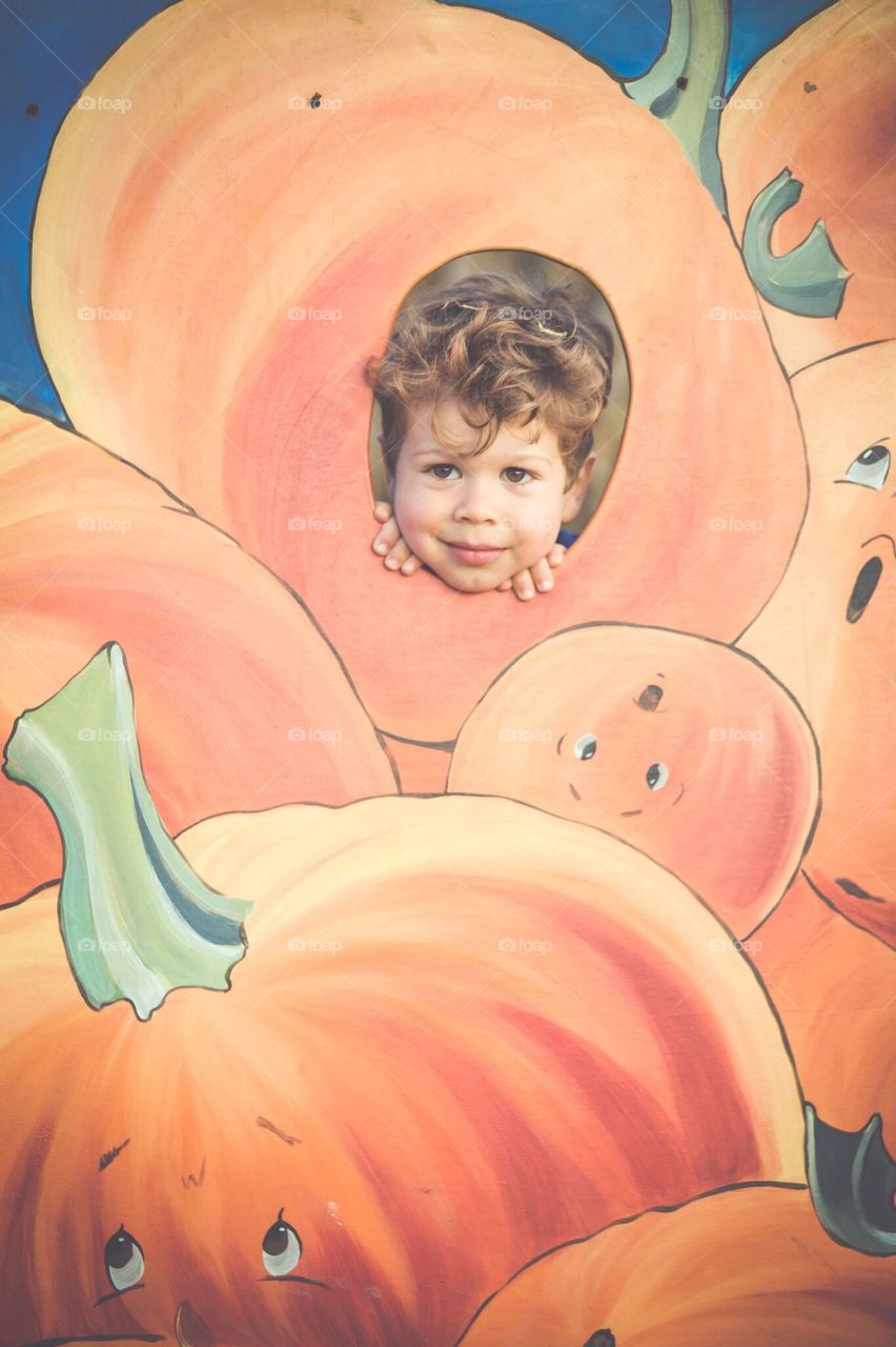 Peeking through the pumpkin at the annual corn maze.