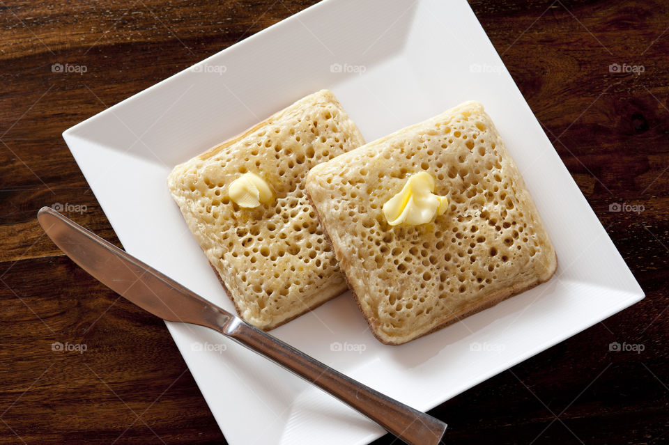 Two square crumpets with butter
