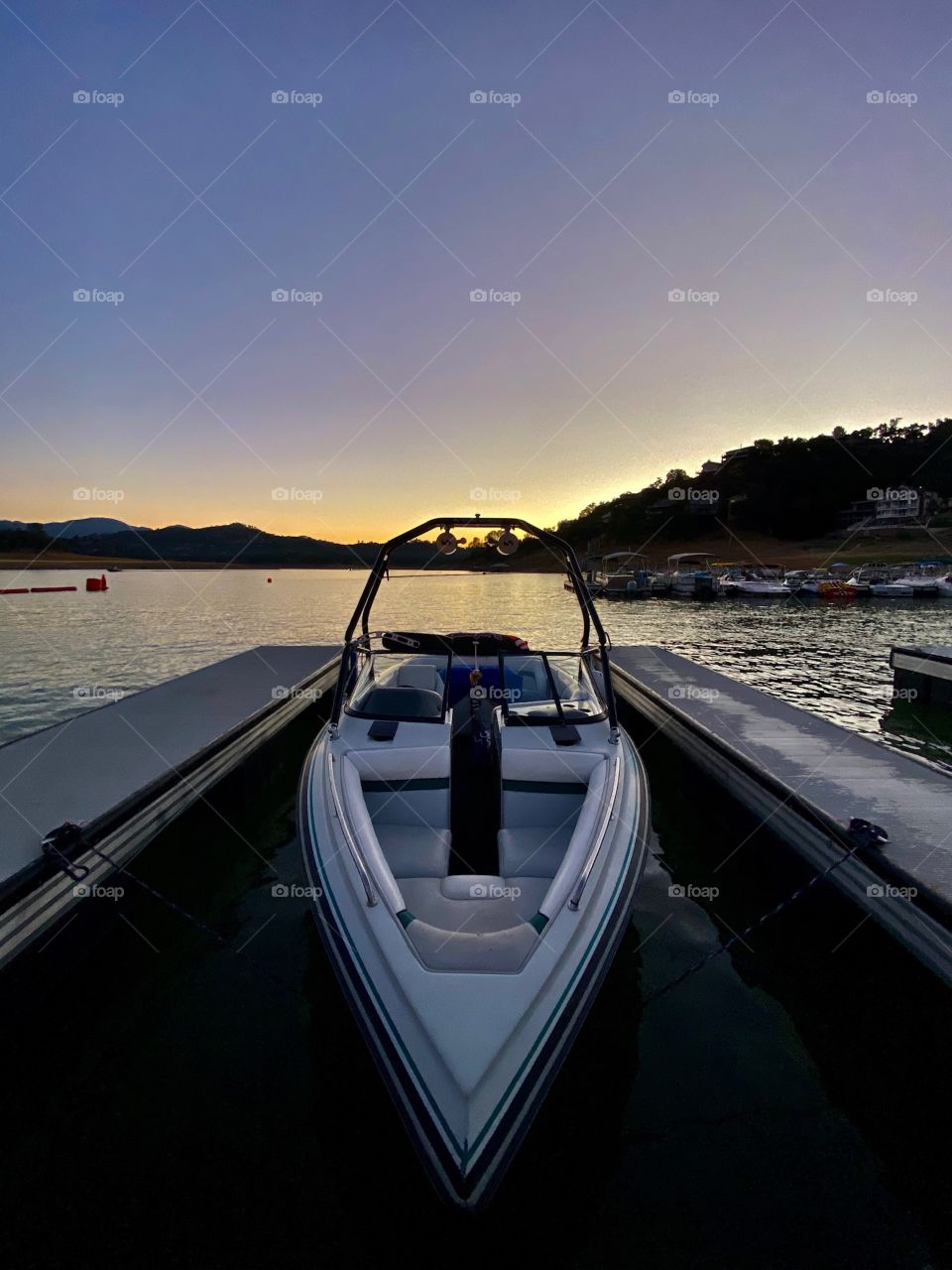 Beautiful sunset at Lake Nacimiento California with a boat in the background 