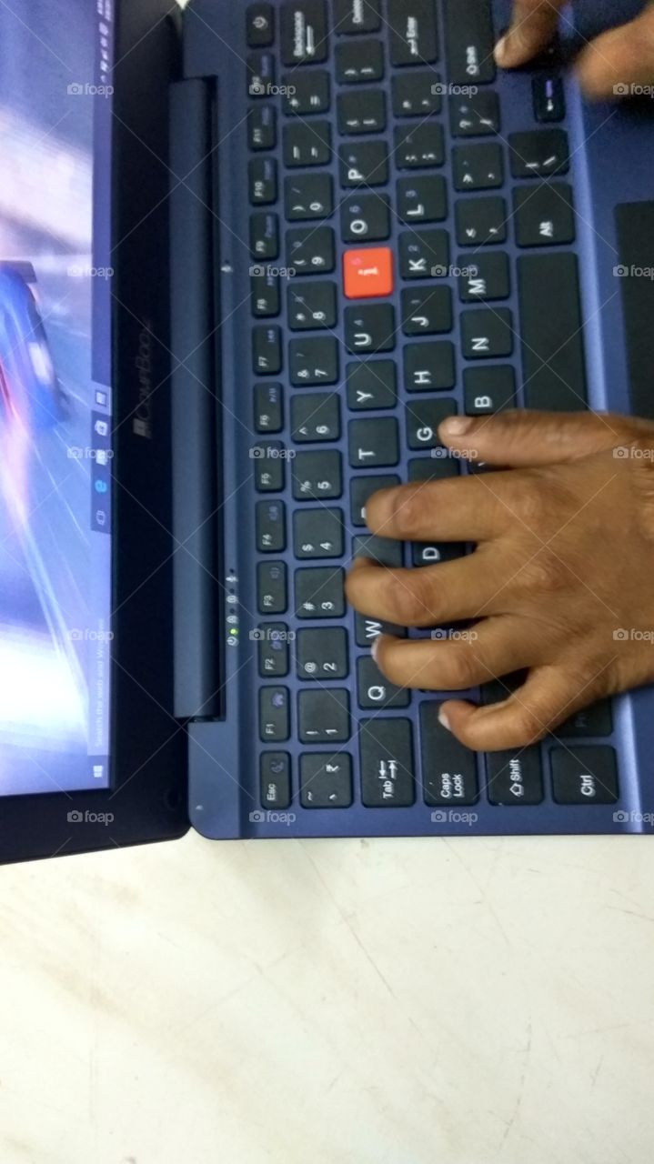 child operating  in laptop playing games