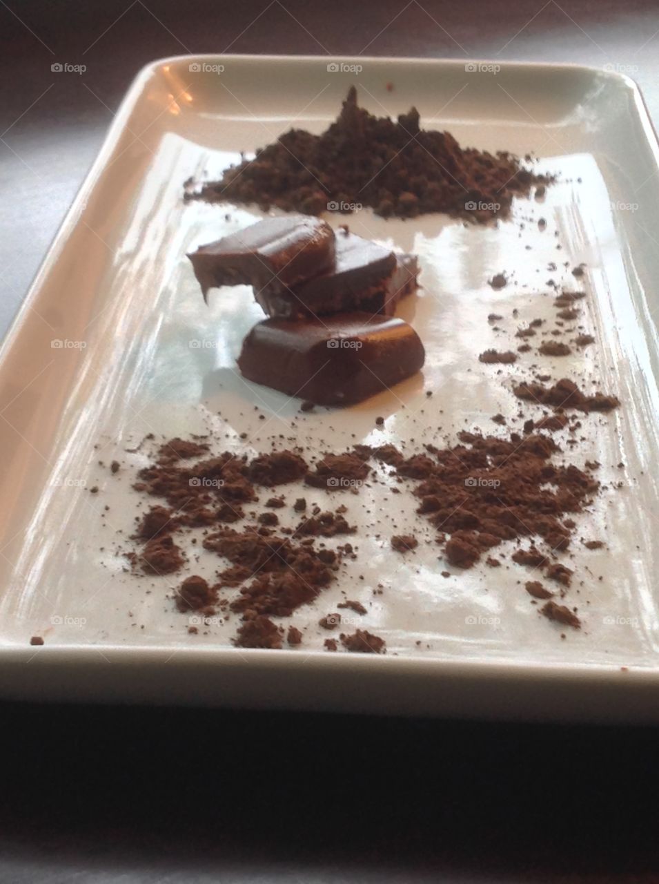 Pieces of fudge with cocoa powder.