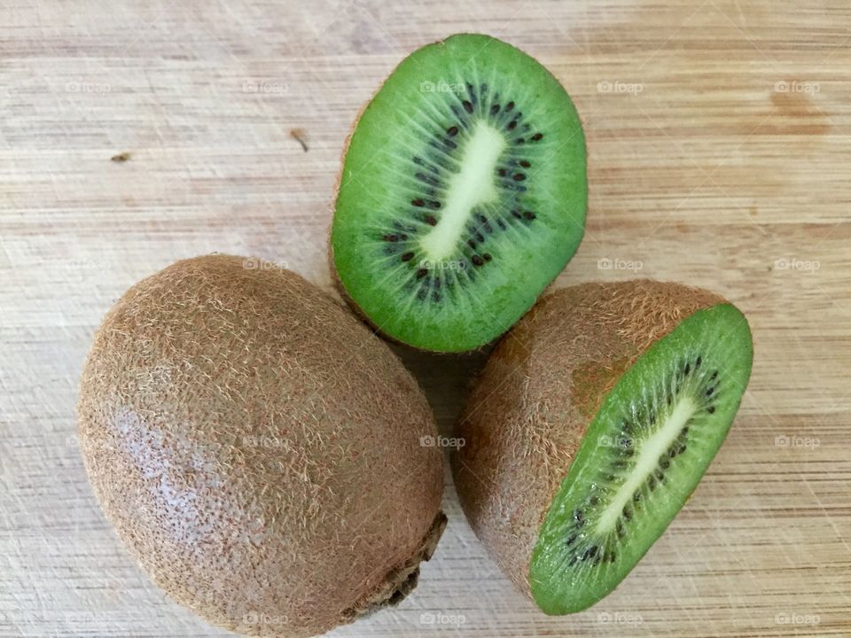 Kiwi fruit on bamboo board