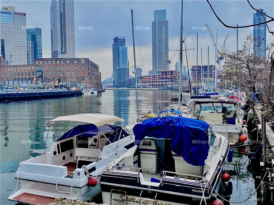 “Newtown Creek” in LIC, Queens, NY on a slightly cloudy afternoon in February, 2023: the surface of the “East River” appears sleek, shiny and highly reflective today. Hypnotic Productions