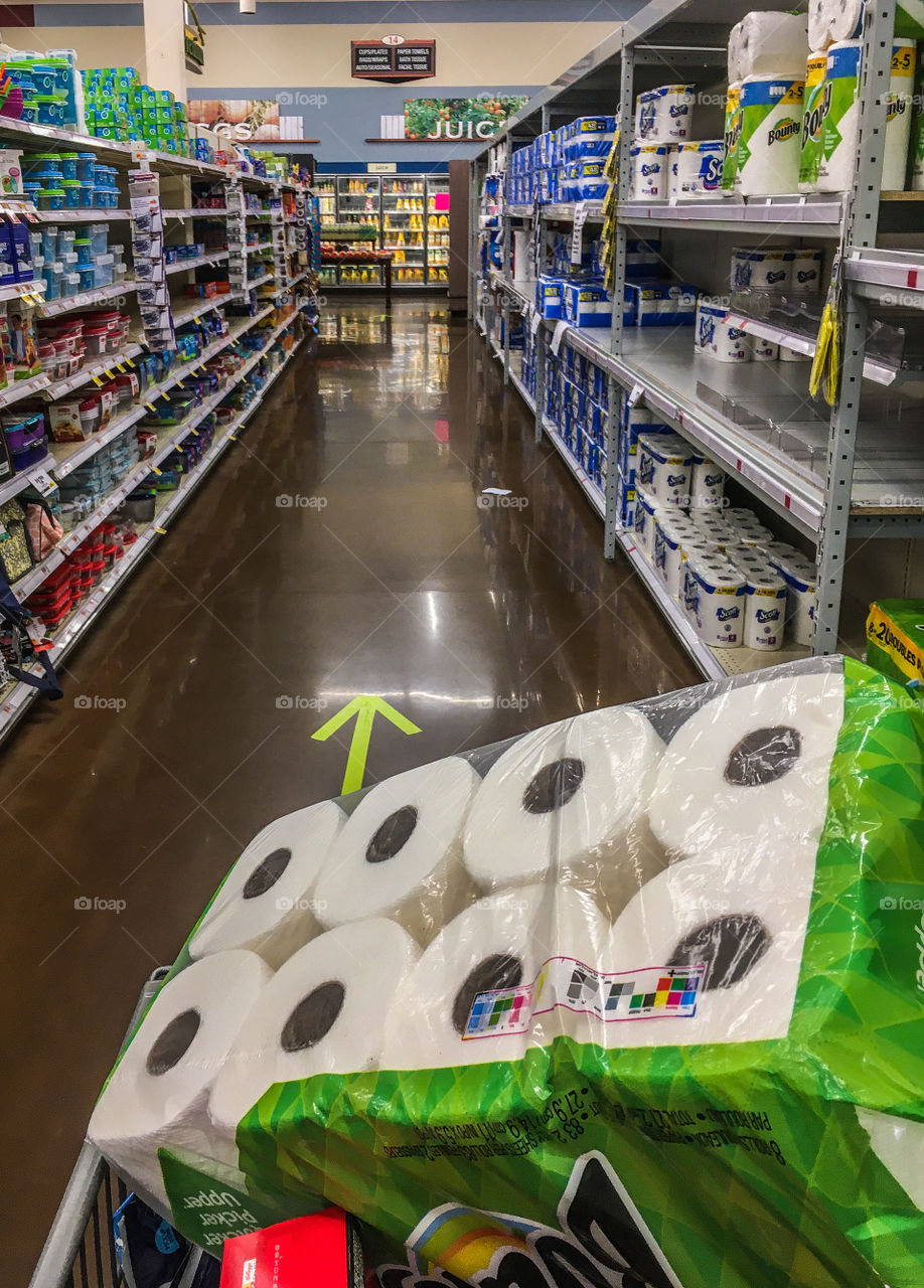 Following socially distant guidelines at the grocery store with one way aisles.  Full cart, empty aisle 