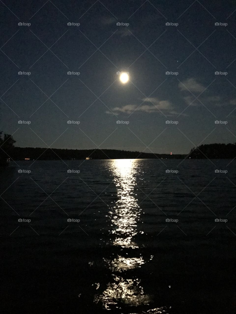 The full moon at night on Thompson's lake in Maine. 