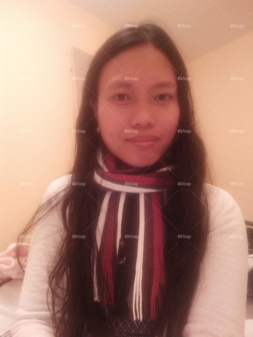 wearing winter stripe scarf and white sweater