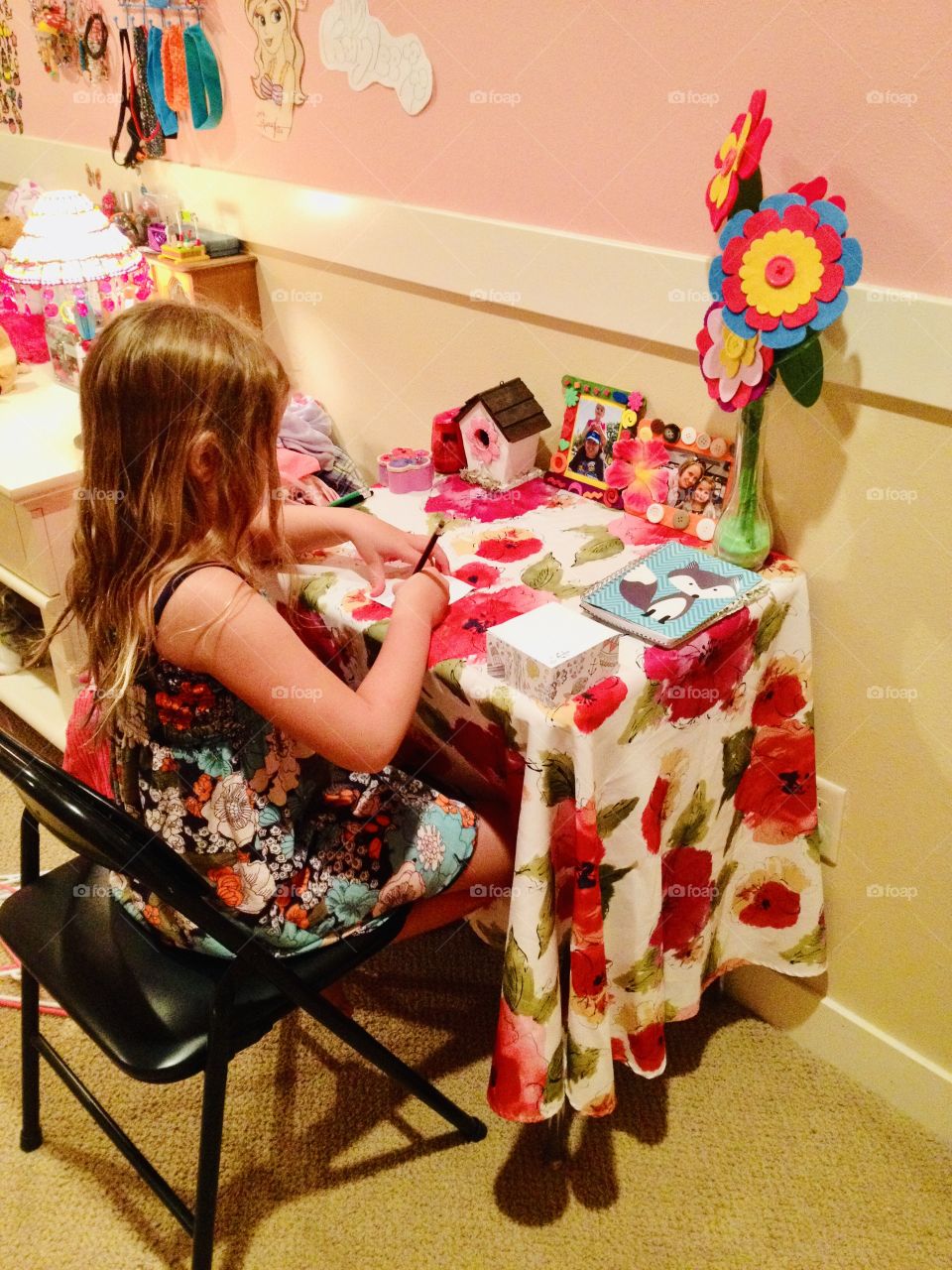Darling little girl in her flowery room at her desk working on a note to someone special!! 