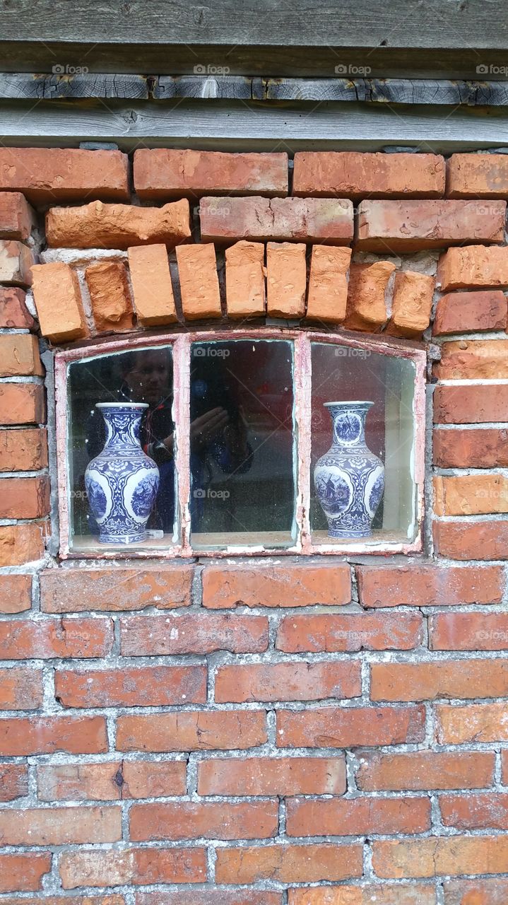 Two decorative vase in window