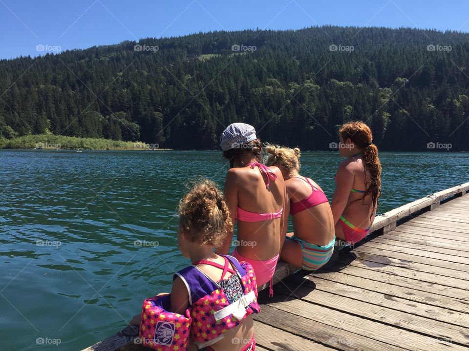 Girls sitting on a dock summer vacation