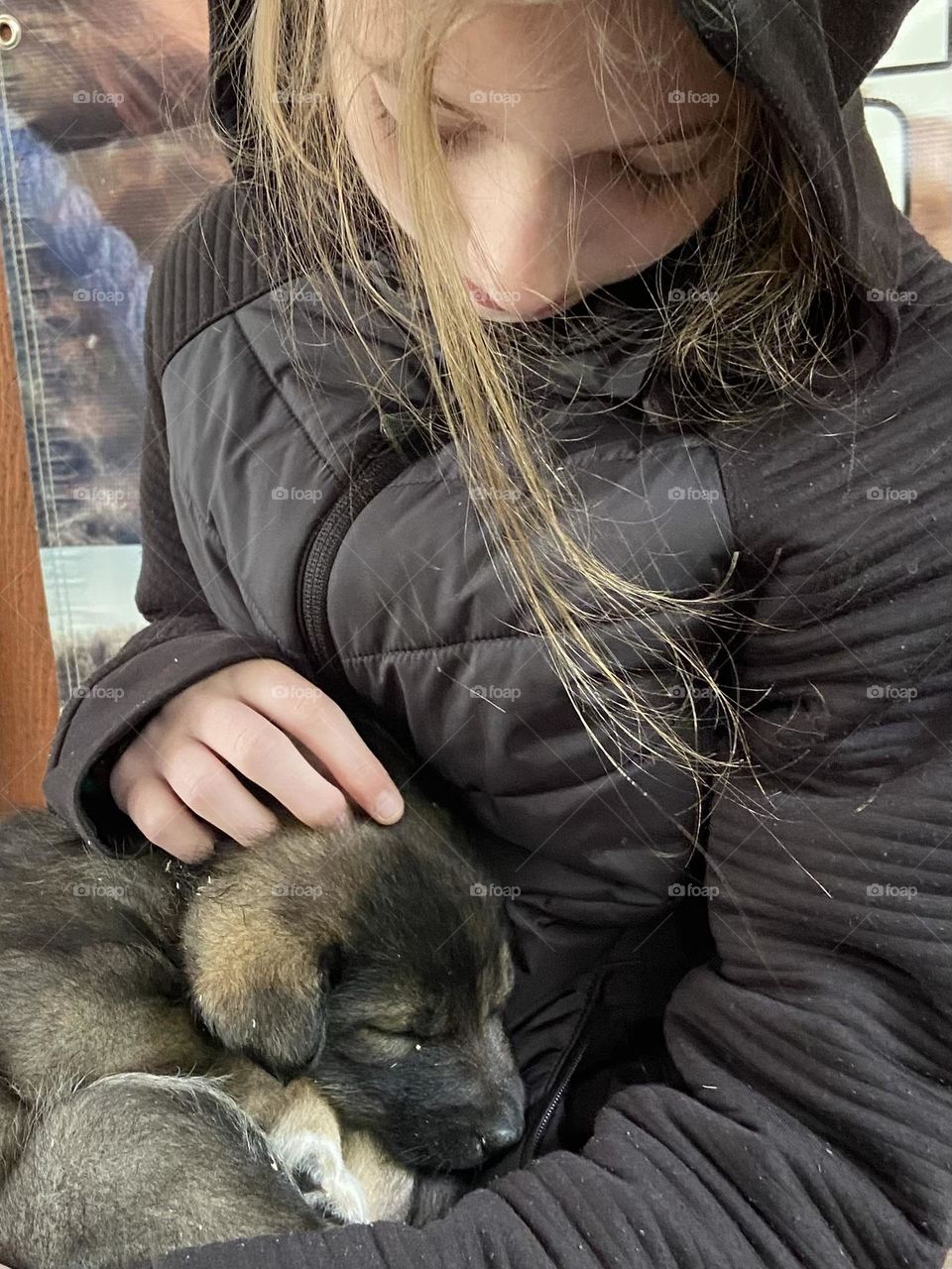 A young girl with her puppy.