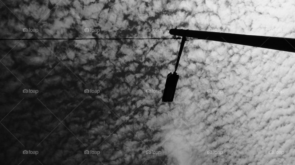 lamp post and clouds. hard and soft. that which is made by man and that which is eternal.