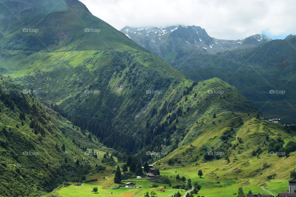 Stunning mountains with houses on a foothill