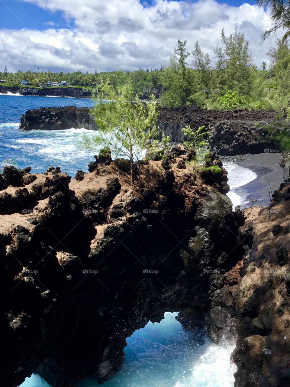 Sea arch and a black sand beach.