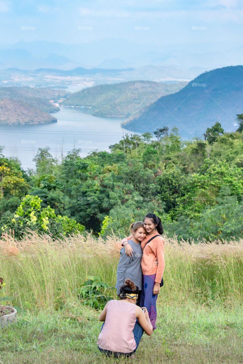 Tourists photograph the beauty inside the dam and the houseboat on the bright sky at Sri Nakarin dam , Kanchana buri in Thailand. December 2, 2018