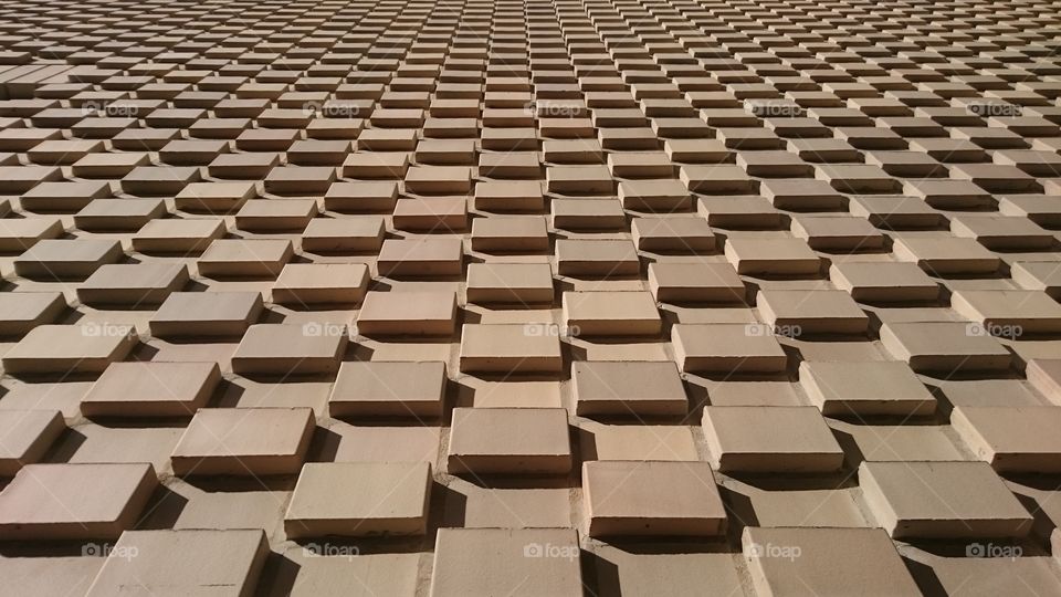 Wall to the north side of the Premier Inn Hotel off of Borough High Street, London. Geometric symmetrical pattern, colour and finish create chocolate like appearance. Shot in Spring.