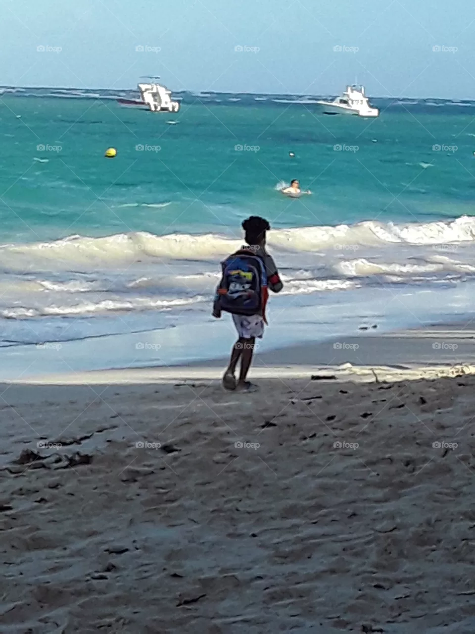 child walks along the beach