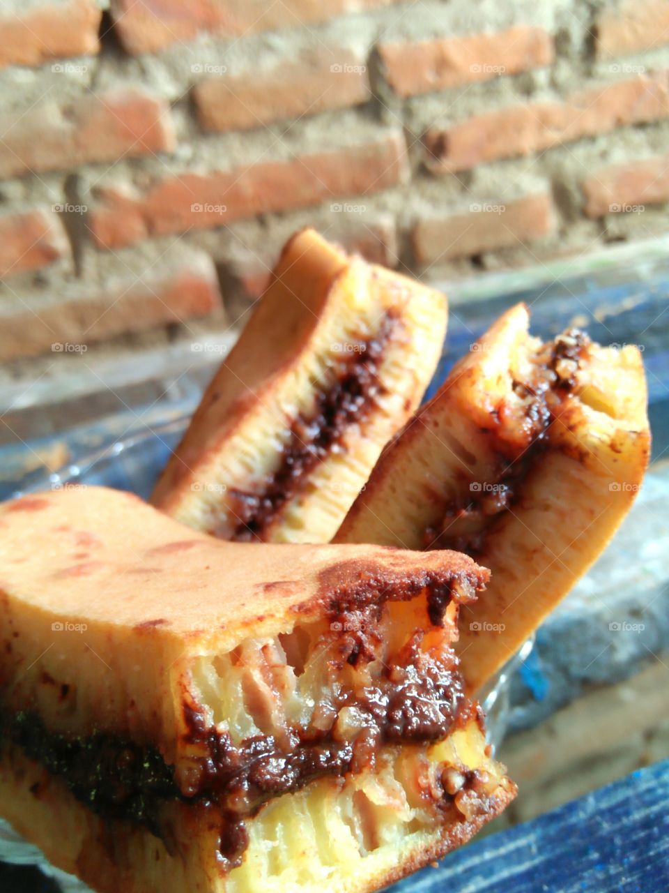 This is Martabak Manis, one of popular snack in Indonesia. It's contain the combination of flour, eggs, and filled by chocolate, roasted peanuts, and condensed milk! You can improve the filler by cheese, jam or candy too!