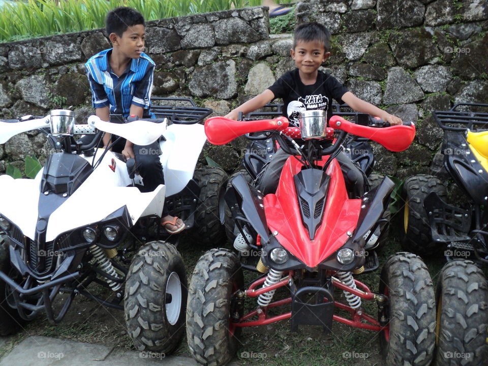 children play motorbikes in the mountains
