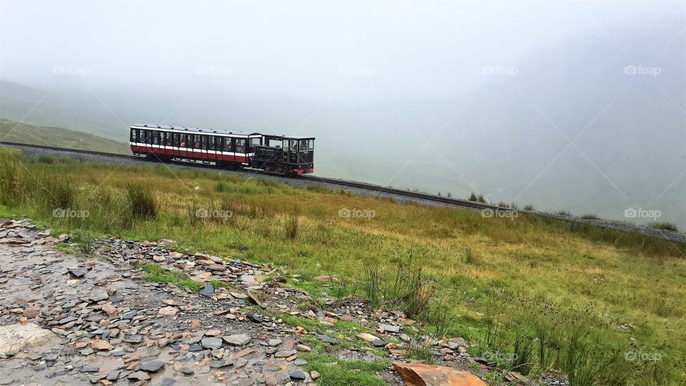 Steam train in the mist: adventure into the unknown. 
The highest mountain in Wale, UK