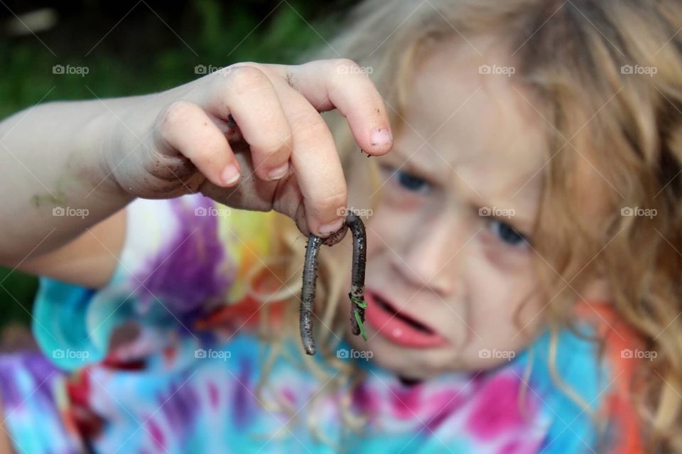 Close-up of a girl holding earthworm