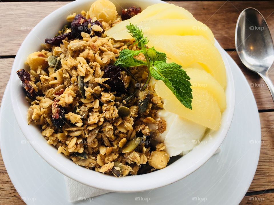 Homemade healthy breakfast: Yoghurt with granola with pear