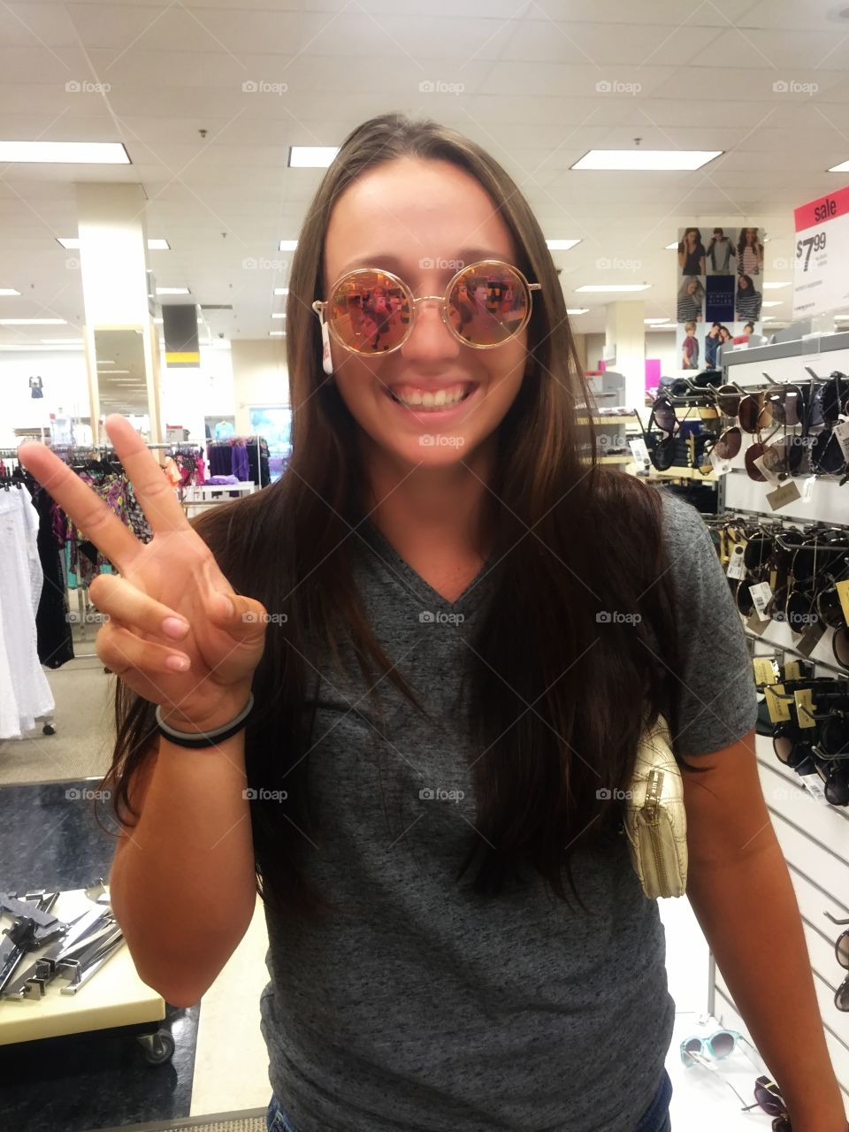 girl shopping for sunglasses