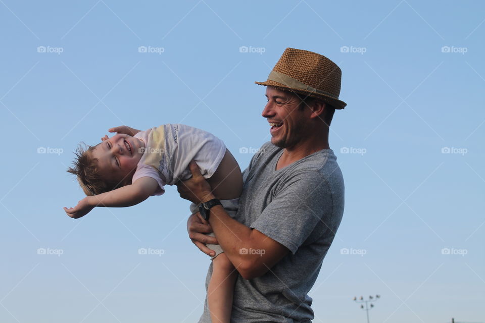 Happy father playing with son