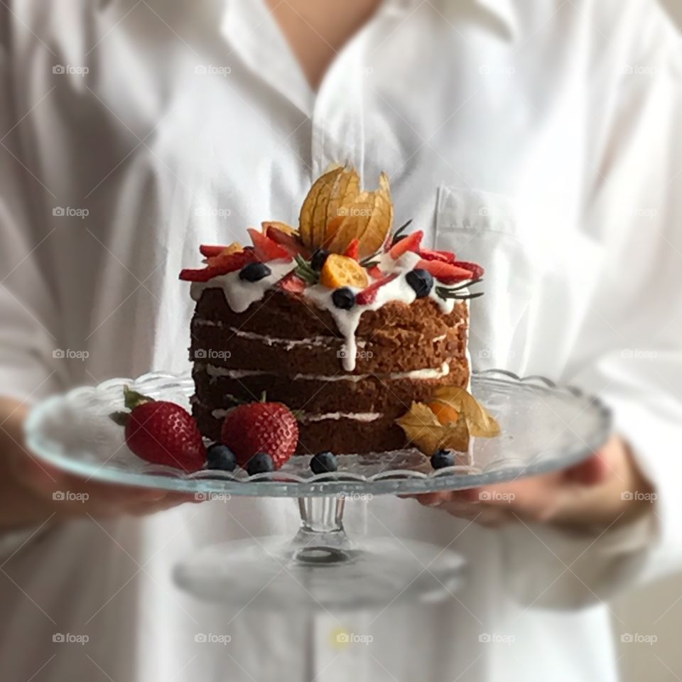 Hand holding chocolate cake