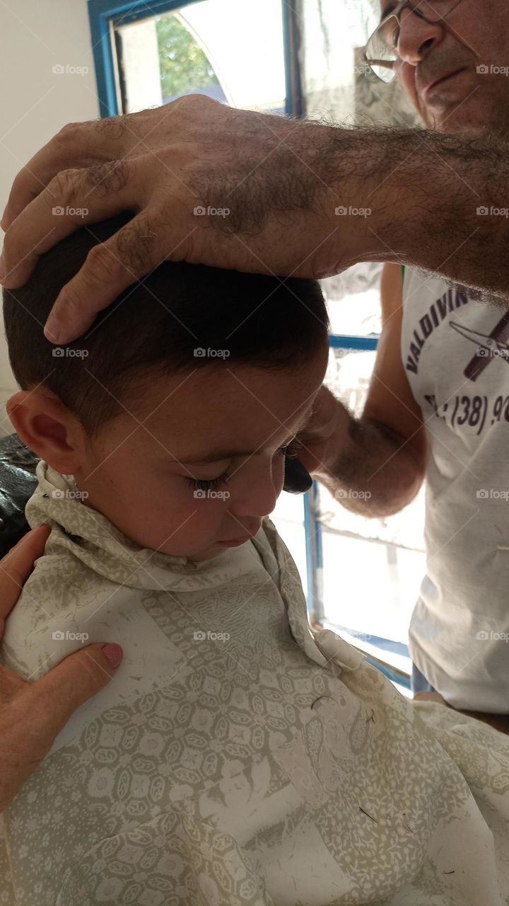 Boy falls asleep while cutting his hair