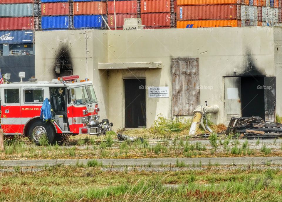 Firetruck Responding To An Emergency. Fire Truck Parked Near A Burned Structure